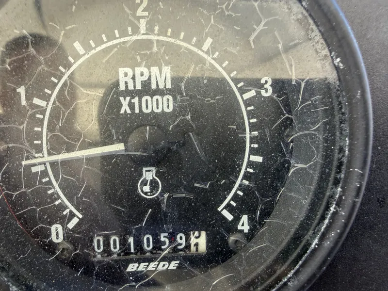 Slide: The Image of A tachometer displays 1059 RPM, with a scratched glass cover. - 20
