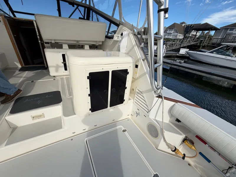 Slide: The Image of The cockpit of a 1993 Rampage Express Sportfish with seating area and fishing rod holders. - 33