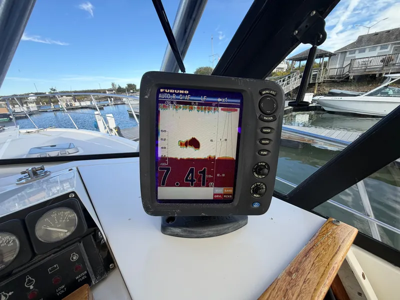Slide: The Image of A fish finder on a boat displays depth information. A marina is visible in the background. - 35