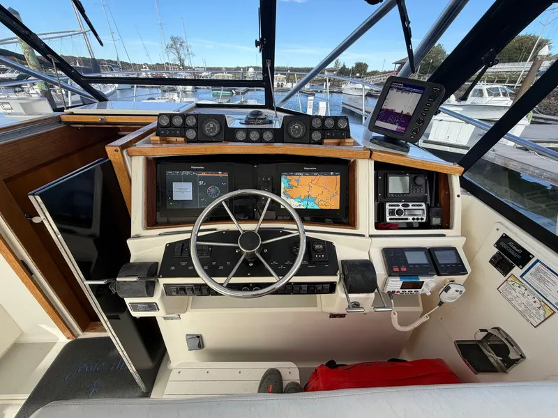 Slide: The Image of The cockpit of a 1993 Rampage Express Sportfish with steering wheel, instruments, and navigation systems. - 40