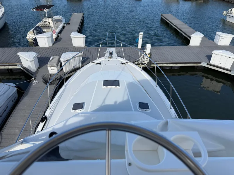 Slide: The Image of A 1993 Rampage Express Sportfish docked in a calm marina, surrounded by other boats. - 24