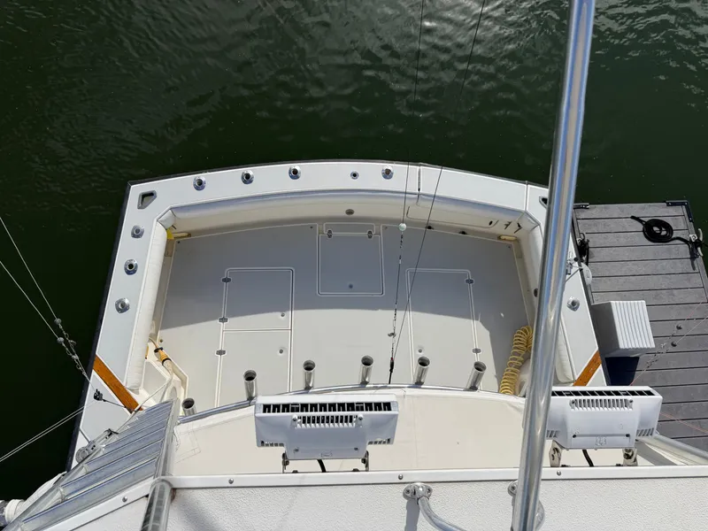 Slide: The Image of Aerial view of a sportfishing boat with spacious deck and rod holders at the dock. - 26