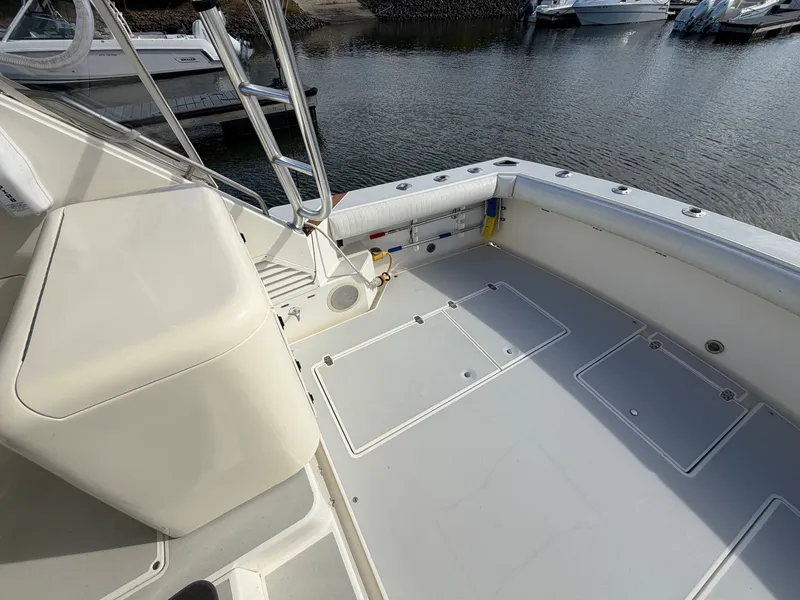 Slide: The Image of The image shows the deck of a 1993 Rampage Express Sportfish with storage and ladders. - 31
