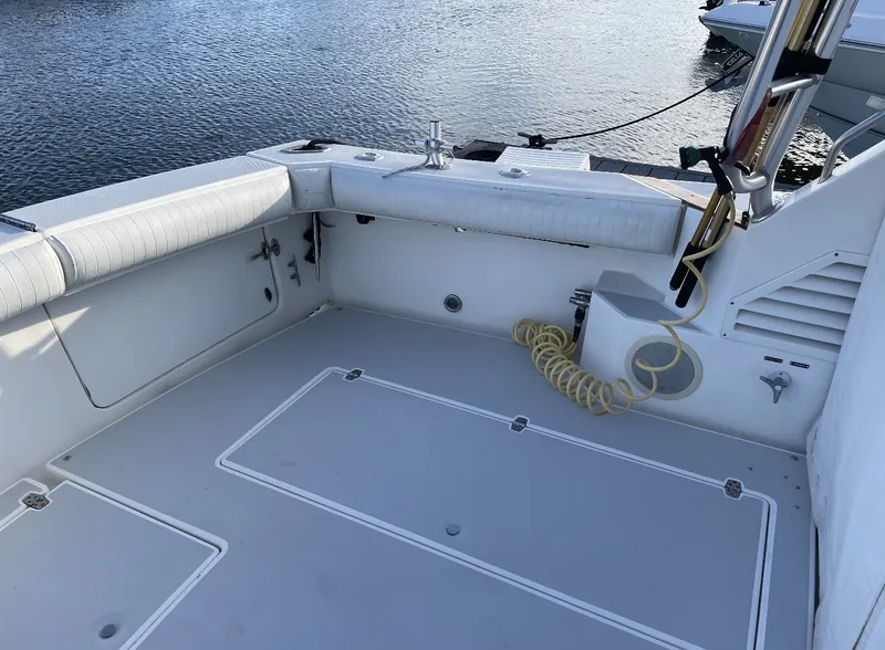 Slide: The Image of The image shows the spacious cockpit of a 1993 Rampage Express Sportfish, docked by the water. - 16