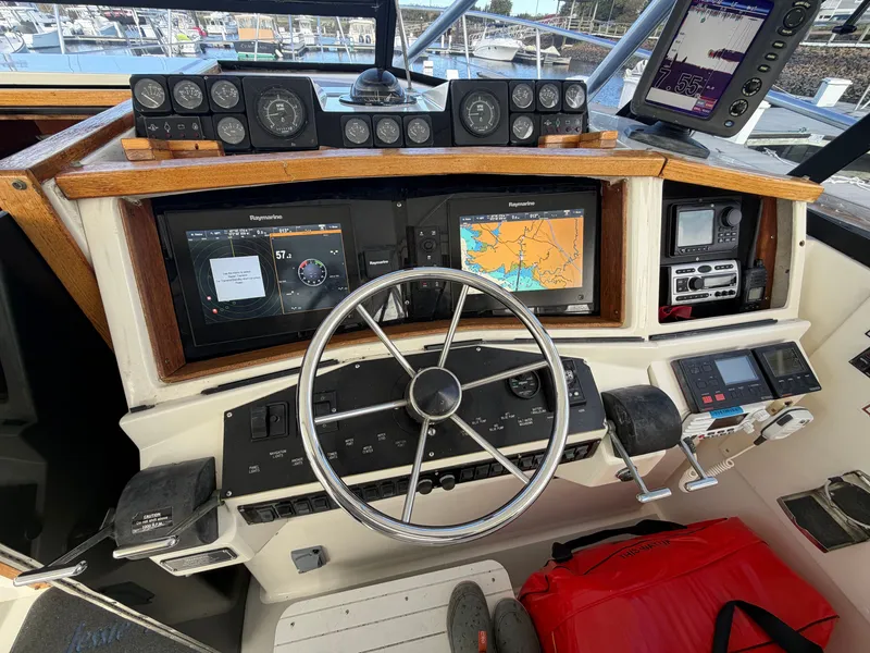 Slide: The Image of The cockpit of a 1993 Rampage Express Sportfish with steering wheel, instruments, and navigation screens. - 34
