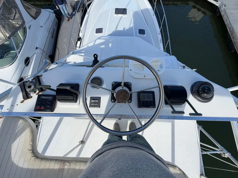 Slide: The Image of The helm of a 1993 Rampage Express Sportfish with various instruments and a large steering wheel. - 25