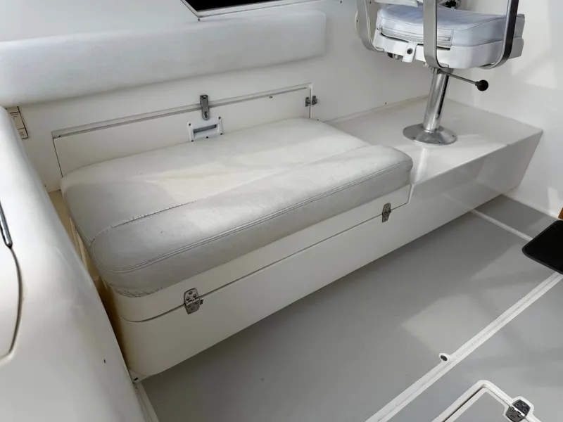 Slide: The Image of A seating area with white upholstery and storage underneath. - 48