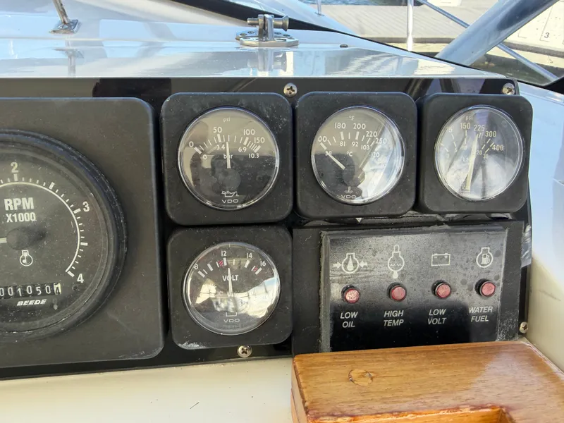 Slide: The Image of Dashboard with various gauges and switches on a boat. - 23