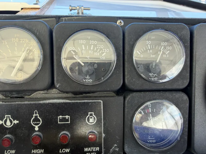 Slide: The Image of Dashboard with various gauges and indicator lights on a boat. - 22