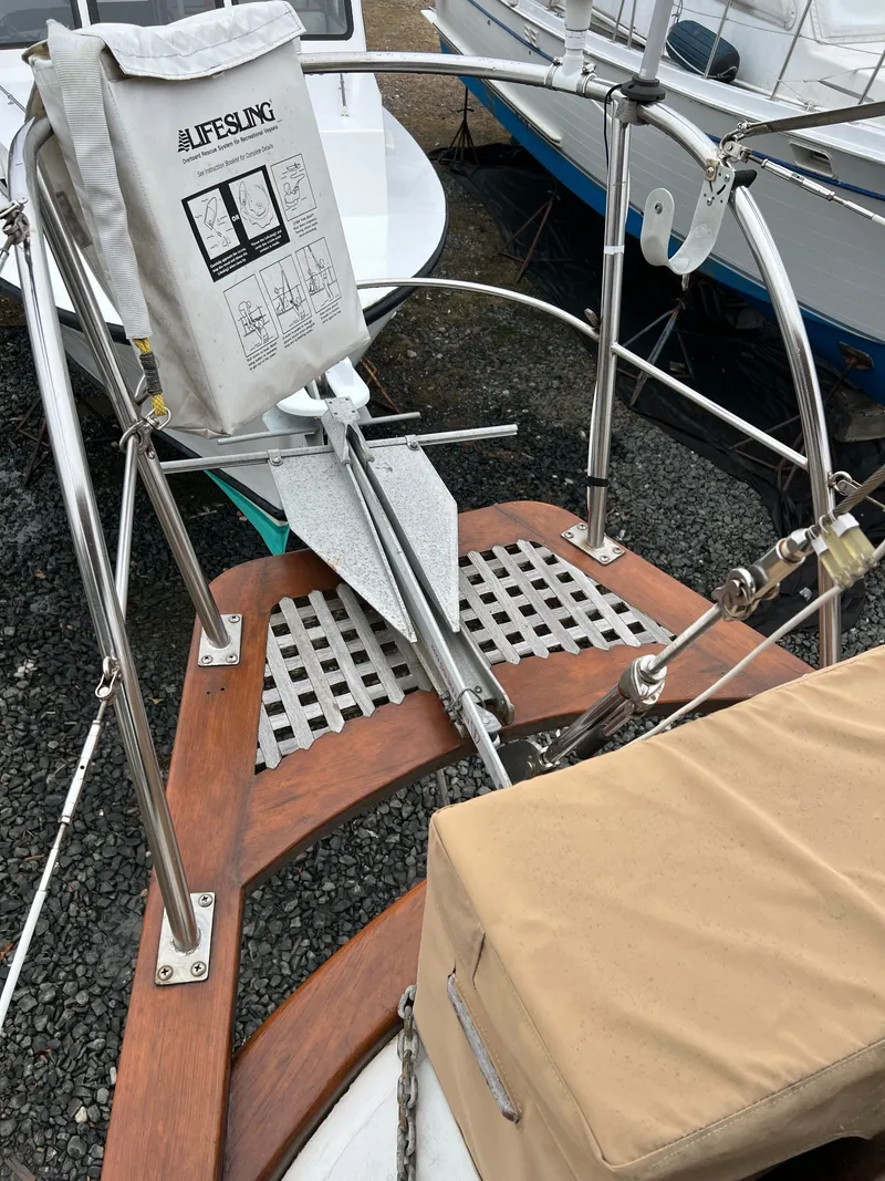 Slide: The Image of The image shows the stern of a 1983 Union Cutter with wood details and a lifebuoy. - 6