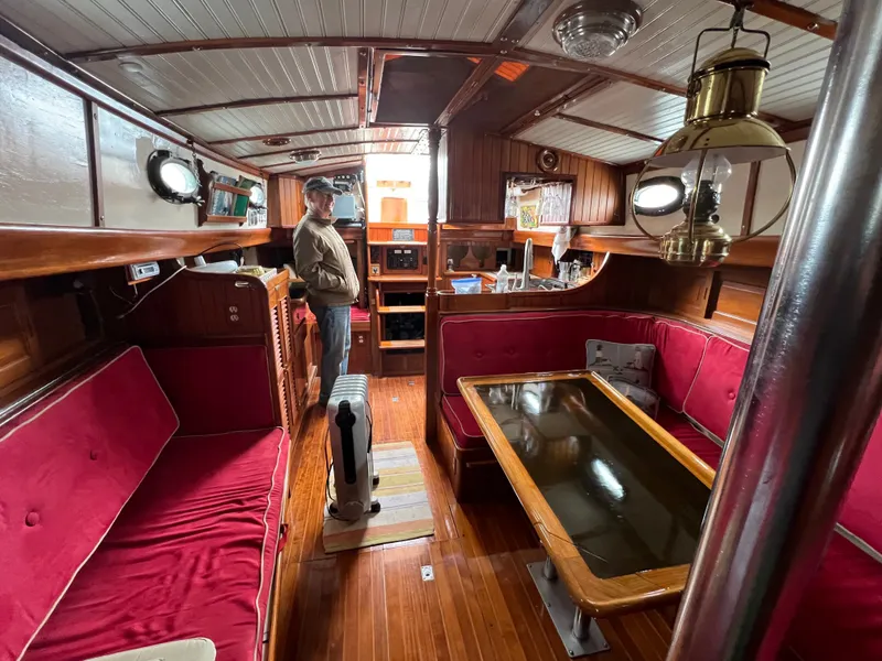 Slide: The Image of Interior of a 1983 Union Cutter with wood finish and red upholstery. - 23