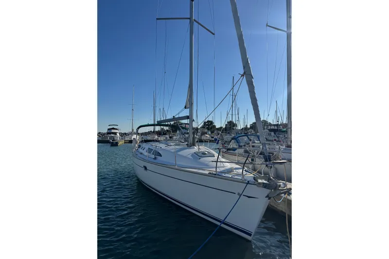 Slide: The Image of 2004 Jeanneau Sun Odyssey 37 sailboat docked in a marina under clear blue skies. - 1