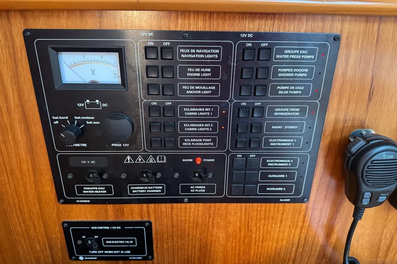 Slide: The Image of Control panel of a 2004 Jeanneau Sun Odyssey 37 sailboat with various switches and a voltmeter. - 10