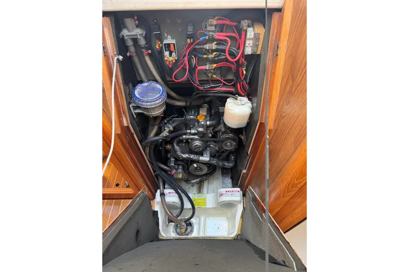 Slide: The Image of Engine compartment of a 2004 Jeanneau Sun Odyssey 37 sailboat, showing wiring and components. - 13
