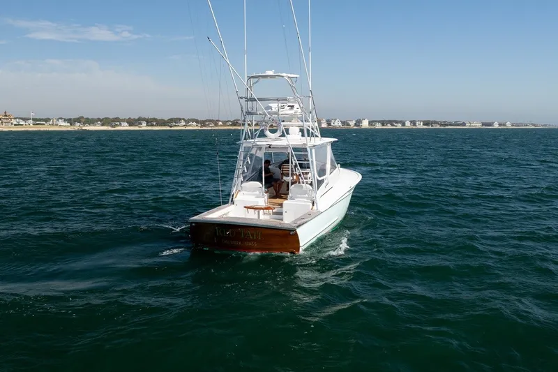 Slide: The Image of 2017 Lightning Custom Yachts 37 Express Sportfish on the water, with a clear view of the stern. - 2