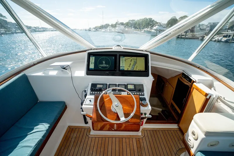 Slide: The Image of The cockpit of a 2017 Lightning Custom Yachts 37 Express Sportfish with wood flooring and modern instruments. - 28