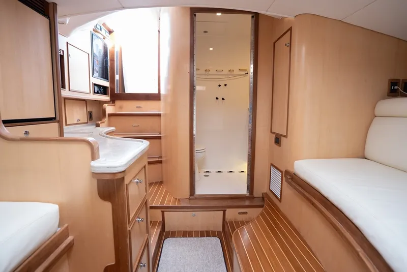 Slide: The Image of Interior of a 2017 Lightning Custom Yachts 37 Express Sportfish with wood flooring and white upholstery. - 46