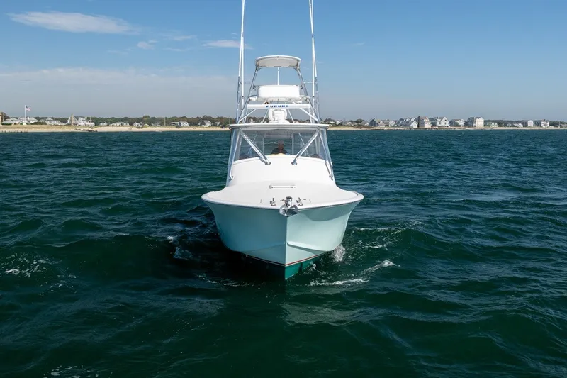 Slide: The Image of A 2017 Lightning Custom Yachts 37 Express Sportfish on the water near a coastline. - 11
