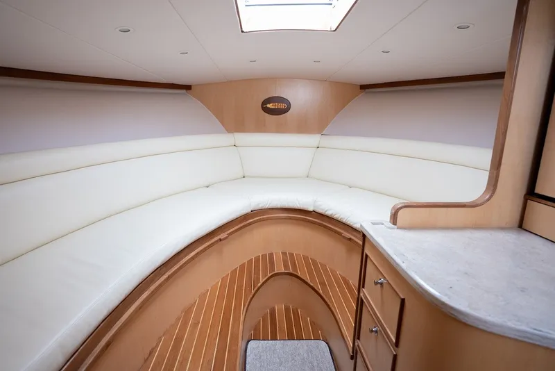 Slide: The Image of Interior of a 2017 Lightning Custom Yachts 37 Express Sportfish with elegant wood paneling and white upholstery. - 45