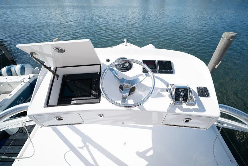 Slide: The Image of Helm of a 2017 Lightning Custom Yachts 37 Express Sportfish with steering wheel and instruments. - 40