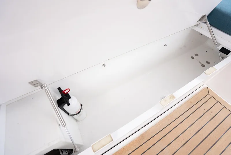 Slide: The Image of Cockpit storage compartment with fire extinguisher, wooden deck flooring. - 36