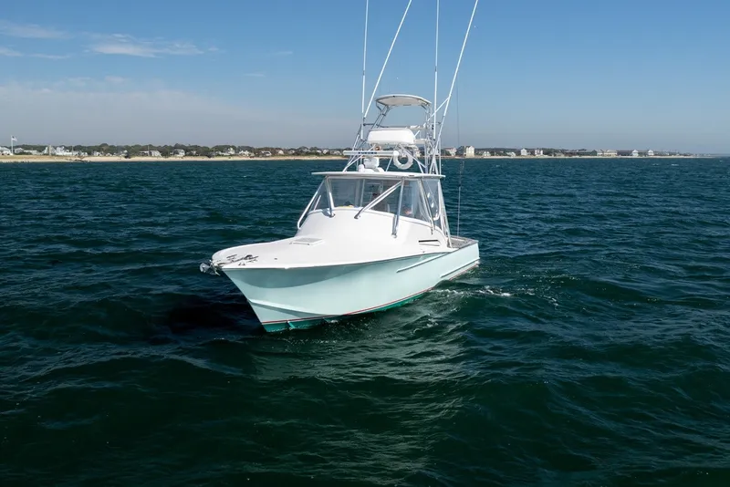 Slide: The Image of A 2017 Lightning Custom Yachts 37 Express Sportfish on the sea with a clear view of the coastline. - 6