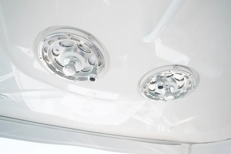 Slide: The Image of Two silver, round vents are mounted on a white ceiling. - 26