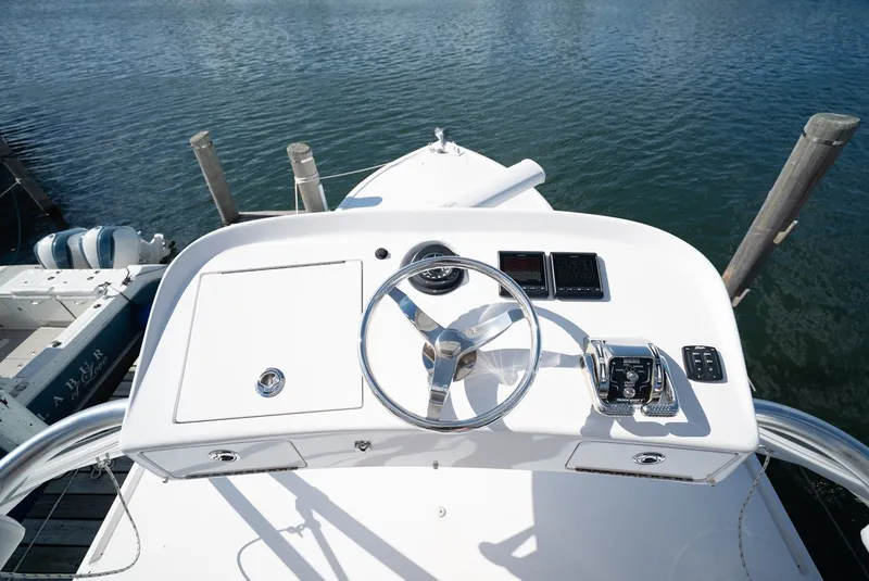 Slide: The Image of Helm of a 2017 Lightning Custom Yachts 37 Express Sportfish with a clear view of the water. - 37