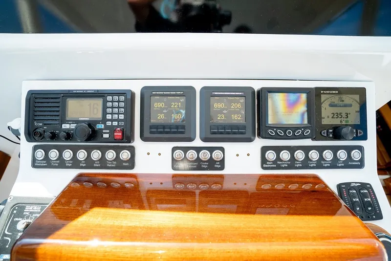 Slide: The Image of The dashboard of a yacht with multiple electronic displays and controls. - 29