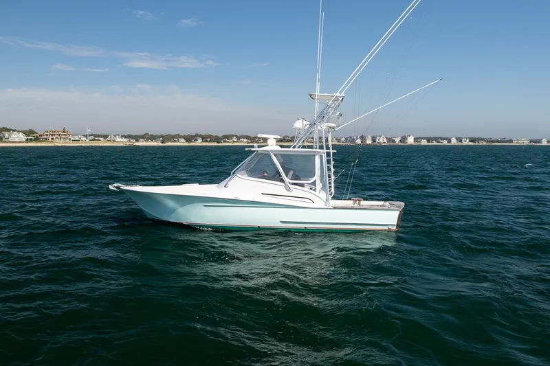 Slide: The Image of 2017 Lightning Custom Yachts 37 Express Sportfish on the water near a coastline. - 5