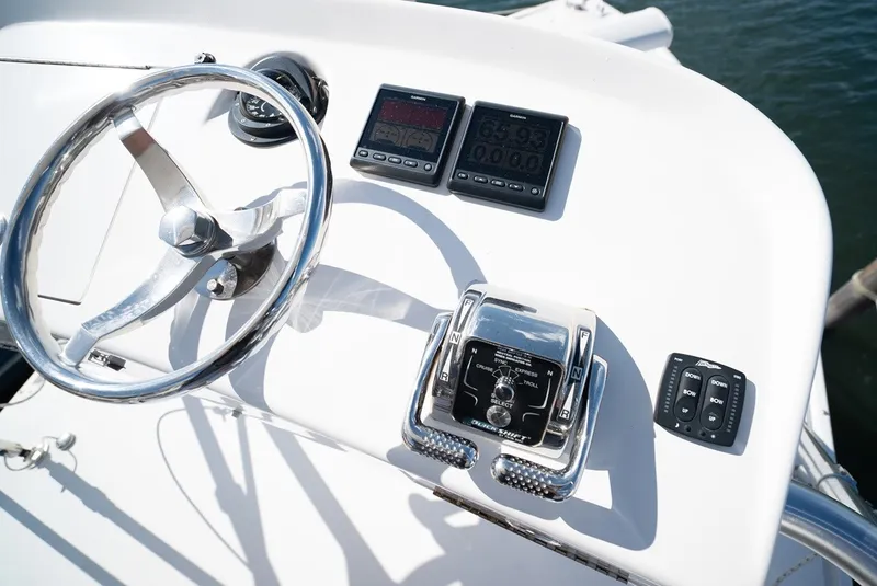 Slide: The Image of Helm of the 2017 Lightning Custom Yachts 37 Express Sportfish with instruments and steering wheel. - 38
