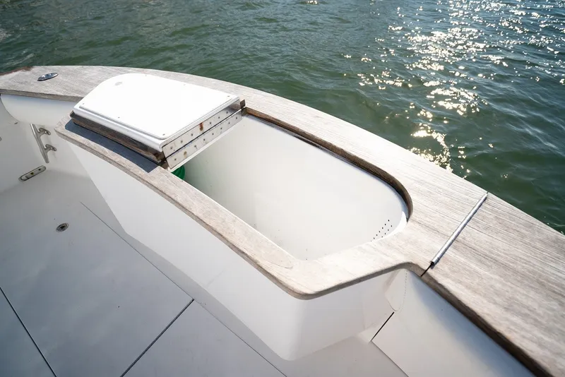 Slide: The Image of The image shows the deck of a 2017 Lightning Custom Yachts 37 Express Sportfish with an open storage area. - 22