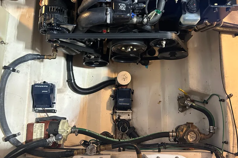 Slide: The Image of Engine compartment of a 2008 Sea Ray Sundancer 260 with visible components and hoses. - 40