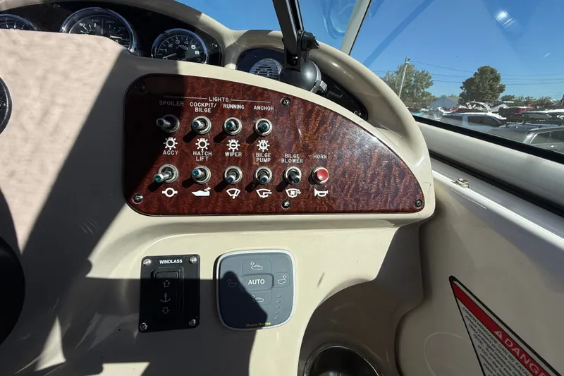 Slide: The Image of Control panel of a 2008 Sea Ray Sundancer 260 boat with various switches and gauges. - 16