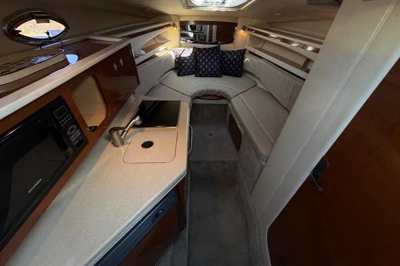 Slide: The Image of Interior of 2008 Sea Ray Sundancer 260 with kitchenette and seating area. - 36