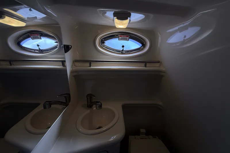 Slide: The Image of Compact bathroom in 2008 Sea Ray Sundancer 260 yacht with sink and porthole window. - 34