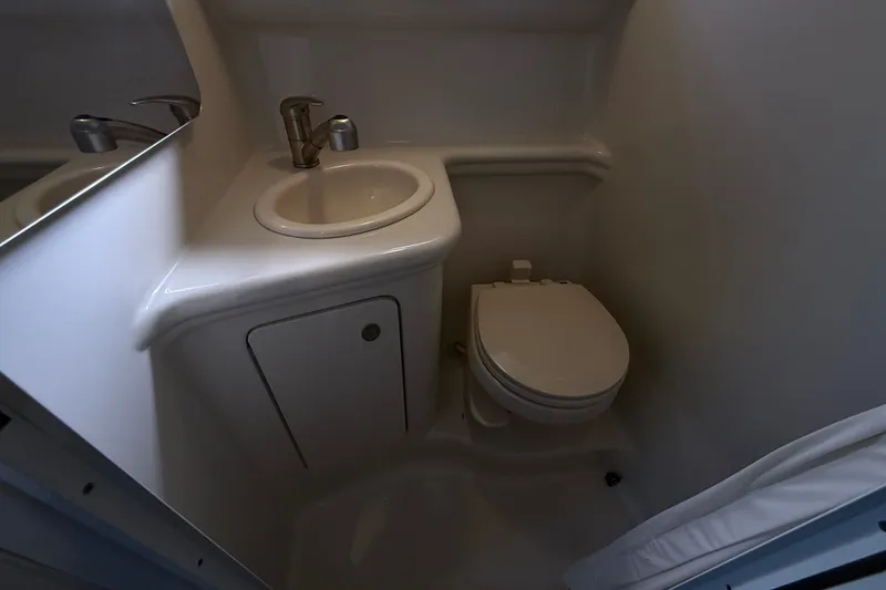 Slide: The Image of Compact bathroom in 2008 Sea Ray Sundancer 260 boat, featuring sink and toilet. - 35