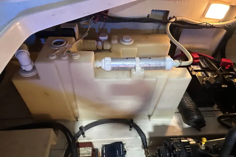 Slide: The Image of Engine compartment of a 2008 Sea Ray Sundancer 260, featuring a water tank and battery setup. - 42