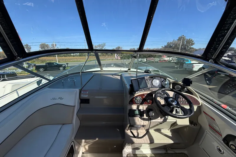 Slide: The Image of Cockpit view of 2008 Sea Ray Sundancer 260 with steering wheel and navigation instruments. - 12