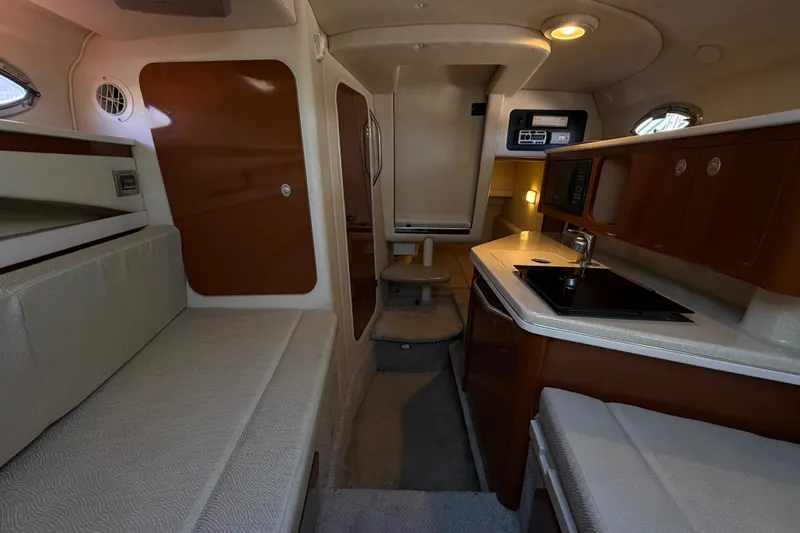 Slide: The Image of 2008 Sea Ray Sundancer 260 cabin interior with kitchenette and seating area. - 31
