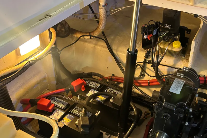 Slide: The Image of Engine compartment of a 2008 Sea Ray Sundancer 260 with visible batteries and wiring. - 44