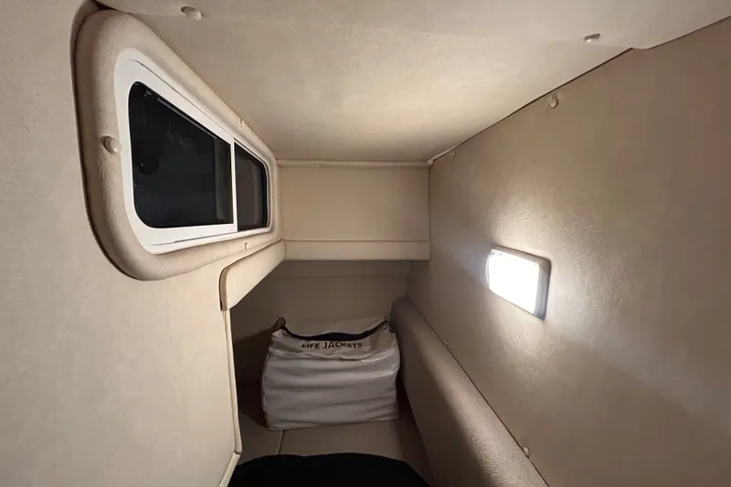 Slide: The Image of Interior cabin of 2008 Sea Ray Sundancer 260 with window and life jackets. - 37
