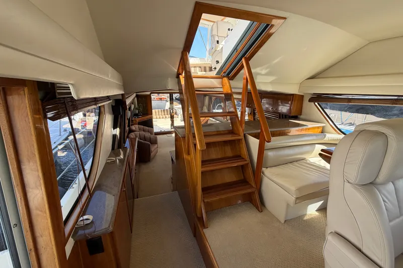 Slide: The Image of Luxurious interior of 2009 Navigator 5800 Pilothouse MY yacht with wooden accents and seating. - 11