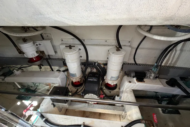 Slide: The Image of Engine room of 2009 Navigator 5800 Pilothouse MY with visible filters and wiring. - 26