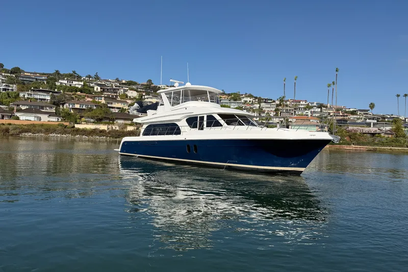 Slide: The Image of 2009 Navigator 5800 Pilothouse MY yacht on calm water near coastal homes. - 5