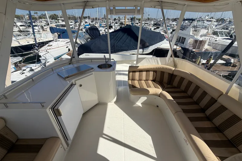 Slide: The Image of Luxurious 2009 Navigator 5800 Pilothouse MY yacht interior with striped seating and marina view. - 20