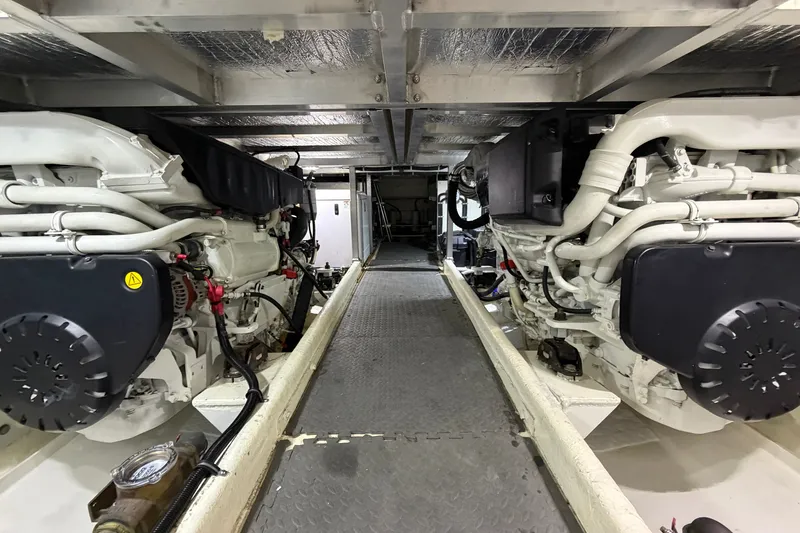 Slide: The Image of Engine room of 2009 Navigator 5800 Pilothouse MY with dual engines and metallic flooring. - 24