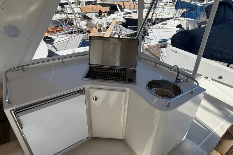 Slide: The Image of Outdoor kitchenette on 2009 Navigator 5800 Pilothouse MY yacht with sink and grill. - 23