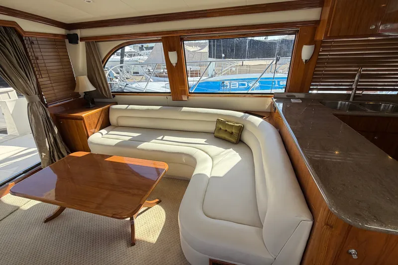 Slide: The Image of Luxurious interior of 2009 Navigator 5800 Pilothouse MY yacht with elegant seating and wooden accents. - 8
