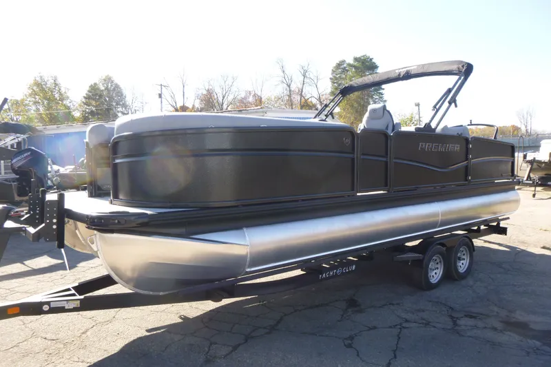 Slide: The Image of 2027 Premier 250 SUNSATION RLO - CL pontoon boat on trailer, parked outdoors. - 8